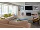 Bright living room featuring a white brick fireplace and large windows with comfortable sofas at 91 Avenida Veneccia, Sarasota, FL 34242