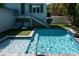 Inviting pool with a jacuzzi and sun loungers, perfect for enjoying sunny days in a serene outdoor space at 91 Avenida Veneccia, Sarasota, FL 34242