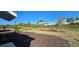 Spacious backyard featuring a grassy area, newly planted trees, mulch beds, and a fence-lined perimeter at 9176 Tequila Sunrise Dr, Sarasota, FL 34241
