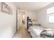 Bright bedroom featuring a floral bedspread, kitchenette, and access to the rest of the house at 1018 Charlotte Ave, Sarasota, FL 34237