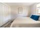 Bright bedroom with a comfortable bed, decorative pillows, and closet with louvered doors at 1018 Charlotte Ave, Sarasota, FL 34237
