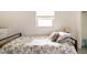 Bright bedroom featuring a floral bedspread, window, and comfortable pillows at 1018 Charlotte Ave, Sarasota, FL 34237