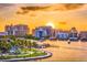 Cityscape view at sunset featuring waterfront condos, lush greenery, and clear skies at 1018 Charlotte Ave, Sarasota, FL 34237