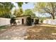 Charming single-story home with a flat roof and well-maintained landscaping and a white fence at 1018 Charlotte Ave, Sarasota, FL 34237