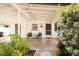 Cozy, covered front porch with seating and decorative plants, perfect for relaxing outdoors at 1018 Charlotte Ave, Sarasota, FL 34237