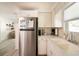 Modern kitchen with stainless steel refrigerator and white cabinetry for ample storage at 1018 Charlotte Ave, Sarasota, FL 34237