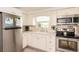 Bright kitchen features stainless steel appliances, white cabinets, and ample counter space at 1018 Charlotte Ave, Sarasota, FL 34237