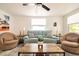 Bright living room with a comfortable blue sofa, accent chairs, and natural light at 1018 Charlotte Ave, Sarasota, FL 34237