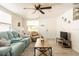 Comfortable living room featuring a blue leather couch and plenty of natural light at 1018 Charlotte Ave, Sarasota, FL 34237