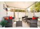 Covered patio featuring comfortable seating with bright cushions and a clear glass table at 1018 Charlotte Ave, Sarasota, FL 34237