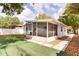 Backyard view of a screened patio that offers additional space for outdoor relaxation at 1018 Charlotte Ave, Sarasota, FL 34237