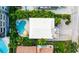Aerial view of a home showcasing a private pool, spa, and outdoor seating areas surrounded by lush greenery at 113 8Th S St, Bradenton Beach, FL 34217