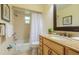 Classic bathroom with a granite-topped vanity, framed mirror, shower-tub combo, and neutral-toned tile at 113 8Th S St, Bradenton Beach, FL 34217