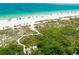 Breathtaking aerial view of a pristine white sand beach with clear turquoise waters, perfect for relaxation and recreation at 113 8Th S St, Bradenton Beach, FL 34217