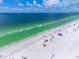 Expansive beach view featuring clear blue waters, soft white sand, and scattered beachgoers enjoying a sunny day at 113 8Th S St, Bradenton Beach, FL 34217