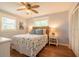 Cozy bedroom featuring a queen-sized bed with nautical-themed bedding, ceiling fan, and hardwood floors at 113 8Th S St, Bradenton Beach, FL 34217