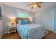 Comfortable bedroom with a ceiling fan, bright windows, a rattan headboard, and wood floors at 113 8Th S St, Bradenton Beach, FL 34217