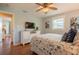 Well-lit bedroom with hardwood floors, coastal decor, a ceiling fan, and large flatscreen TV at 113 8Th S St, Bradenton Beach, FL 34217