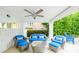 Inviting outdoor patio with comfortable seating, ceiling fan, and view of the surrounding greenery at 113 8Th S St, Bradenton Beach, FL 34217