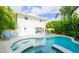 Private pool with a spa and poolside lounge seating in a tropical landscaped backyard at 113 8Th S St, Bradenton Beach, FL 34217