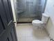 Bathroom featuring a glass-enclosed shower with a built-in seat and a modern toilet at 11516 Sweetflag Dr, Lakewood Ranch, FL 34202
