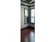 Bedroom featuring hardwood floors, gray walls, decorative crown molding, and dual windows at 11516 Sweetflag Dr, Lakewood Ranch, FL 34202