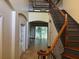 View of foyer with tile flooring, staircase with rod iron spindles, and high ceilings at 11516 Sweetflag Dr, Lakewood Ranch, FL 34202