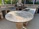 Outdoor kitchen featuring granite countertops, a table with a decorative base, and a brick pizza oven at 11516 Sweetflag Dr, Lakewood Ranch, FL 34202
