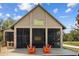 Exterior of community center with rocking chairs on the deck and screened windows at 11591 Little River Way, Parrish, FL 34219