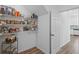 Walk-in pantry features an organized storage system with wood-look floors at 11591 Little River Way, Parrish, FL 34219