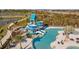 Outdoor pool area with a thrilling water slide, lounge chairs, and shaded seating, offering a perfect spot for Gathering fun at 11591 Little River Way, Parrish, FL 34219