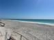 Wide sandy beach with calm ocean waters and stairs at 1190 Shore View Dr # C, Englewood, FL 34223
