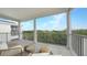 Relaxing covered balcony with outdoor seating, nature views, and gray deck floors at 12415 Dockside Ter, Cortez, FL 34215