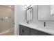 Modern bathroom with a double vanity with quartz countertops and a glass shower at 12415 Dockside Ter, Cortez, FL 34215