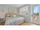 Comfortable bedroom featuring a cozy bed, plantation shutters, and an exterior door at 12415 Dockside Ter, Cortez, FL 34215