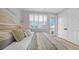 Relaxing bedroom with a cozy bed, neutral tones, and access to balcony at 12415 Dockside Ter, Cortez, FL 34215