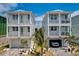 Beautiful new homes with garages and balconies, complemented by lush palm trees at 12415 Dockside Ter, Cortez, FL 34215