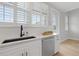 Kitchen sink area featuring bright white subway tile, white countertop and black sink with stainless steel appliances at 12415 Dockside Ter, Cortez, FL 34215