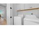 Convenient laundry room with washer, dryer, and white storage cabinets at 12415 Dockside Ter, Cortez, FL 34215