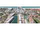 High angle aerial view showing waterfront condo community with canal, boat dock, and tennis courts at 1250 N Portofino Dr # 304, Sarasota, FL 34242