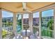Enclosed balcony with seating offers waterfront views of the canal and neighboring condos at 1250 N Portofino Dr # 304, Sarasota, FL 34242