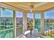 Enclosed balcony features a table and chairs with canal views and surrounding building views at 1250 N Portofino Dr # 304, Sarasota, FL 34242