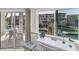 Inviting balcony view features outdoor seating and canal views, framed by palm trees and serene waters at 1250 N Portofino Dr # 304, Sarasota, FL 34242