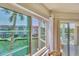 Balcony view featuring a table and chairs overlooking the lush landscaping and water at 1250 N Portofino Dr # 304, Sarasota, FL 34242