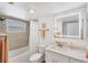 Bathroom featuring a vanity, large mirror, and shower with updated fixtures and neutral tiling at 1250 N Portofino Dr # 304, Sarasota, FL 34242