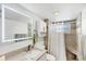 Modern bathroom featuring a vanity, large mirror, shower, and tiled walls at 1250 N Portofino Dr # 304, Sarasota, FL 34242