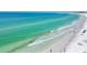 Stunning beach view with turquoise water, soft white sand, and people enjoying the ocean at 1250 N Portofino Dr # 304, Sarasota, FL 34242