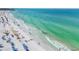 A sunny beach with white sand, turquoise water, and people enjoying the view at 1250 N Portofino Dr # 304, Sarasota, FL 34242