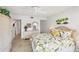 Inviting bedroom with tropical decor, light wood floors, and a view into other rooms at 1250 N Portofino Dr # 304, Sarasota, FL 34242