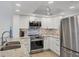 Stylish kitchen with stainless steel appliances, granite countertops, and white cabinetry at 1250 N Portofino Dr # 304, Sarasota, FL 34242